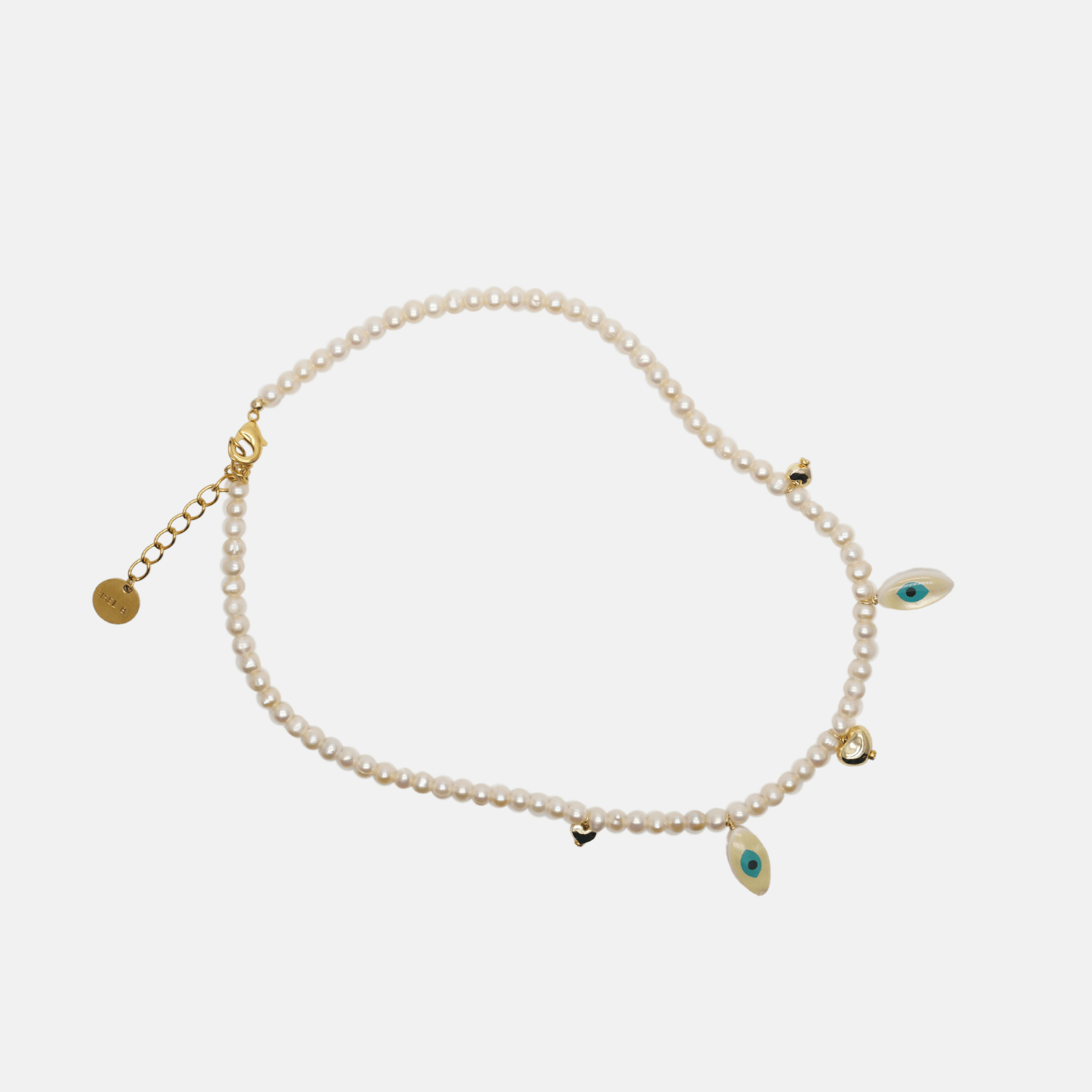 Collier grigri Chipote pas x Gisel B en perles de culture rondes et nacre œil protecteur